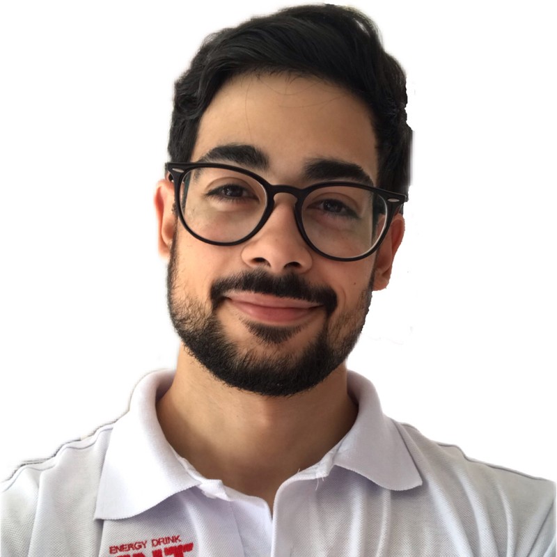 Felipe Campelo smiling in a red plaid shirt and tortoise shell glasses